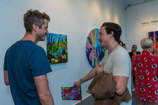 People inside Carousel Fine Art's Miami gallery space during Neill Wright's exhibition "Where the Light Gets In."