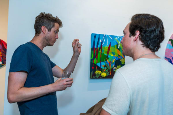 People inside Carousel Fine Art's Miami gallery space during Neill Wright's exhibition "Where the Light Gets In."