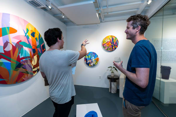 People inside Carousel Fine Art's Miami gallery space during Neill Wright's exhibition "Where the Light Gets In."