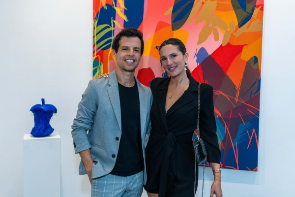 People inside Carousel Fine Art's Miami gallery space during Neill Wright's exhibition "Where the Light Gets In."