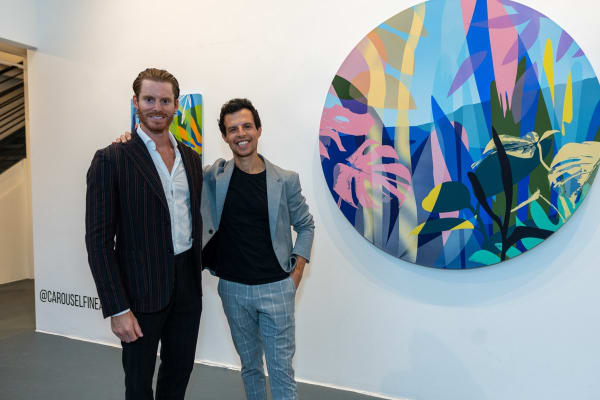 People inside Carousel Fine Art's Miami gallery space during Neill Wright's exhibition "Where the Light Gets In."