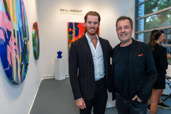 People inside Carousel Fine Art's Miami gallery space during Neill Wright's exhibition "Where the Light Gets In."
