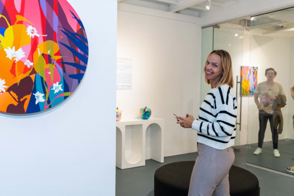 People inside Carousel Fine Art's Miami gallery space during Neill Wright's exhibition "Where the Light Gets In."