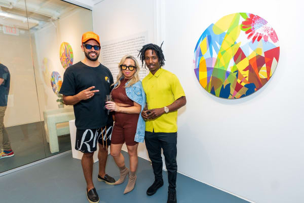 People inside Carousel Fine Art's Miami gallery space during Neill Wright's exhibition "Where the Light Gets In."