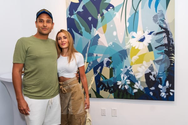 People inside Carousel Fine Art's Miami gallery space during Neill Wright's exhibition "Where the Light Gets In."
