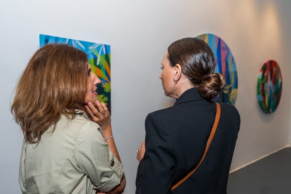 People inside Carousel Fine Art's Miami gallery space during Neill Wright's exhibition "Where the Light Gets In."