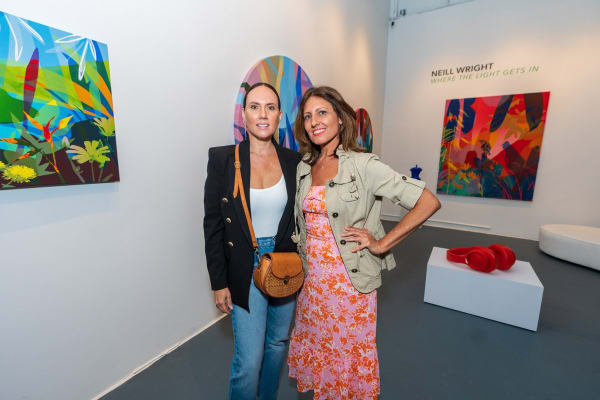 People inside Carousel Fine Art's Miami gallery space during Neill Wright's exhibition "Where the Light Gets In."