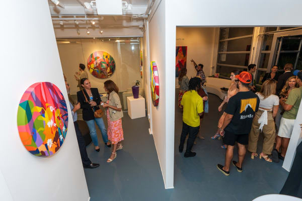 People inside Carousel Fine Art's Miami gallery space during Neill Wright's exhibition "Where the Light Gets In."
