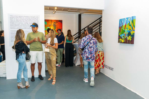 People inside Carousel Fine Art's Miami gallery space during Neill Wright's exhibition "Where the Light Gets In."