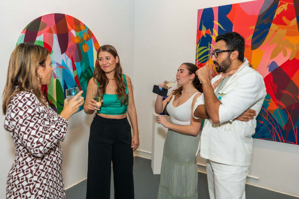 People inside Carousel Fine Art's Miami gallery space during Neill Wright's exhibition "Where the Light Gets In."