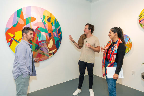 People inside Carousel Fine Art's Miami gallery space during Neill Wright's exhibition "Where the Light Gets In."