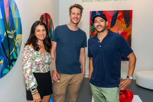 People inside Carousel Fine Art's Miami gallery space during Neill Wright's exhibition "Where the Light Gets In."