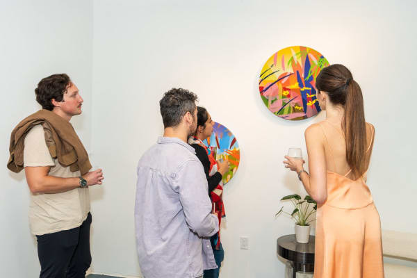 People inside Carousel Fine Art's Miami gallery space during Neill Wright's exhibition "Where the Light Gets In."