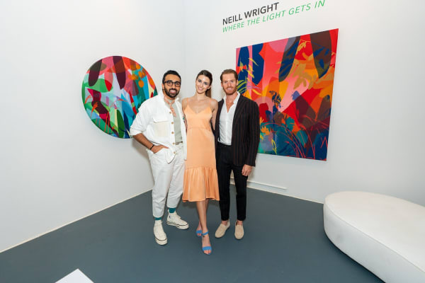People inside Carousel Fine Art's Miami gallery space during Neill Wright's exhibition "Where the Light Gets In."