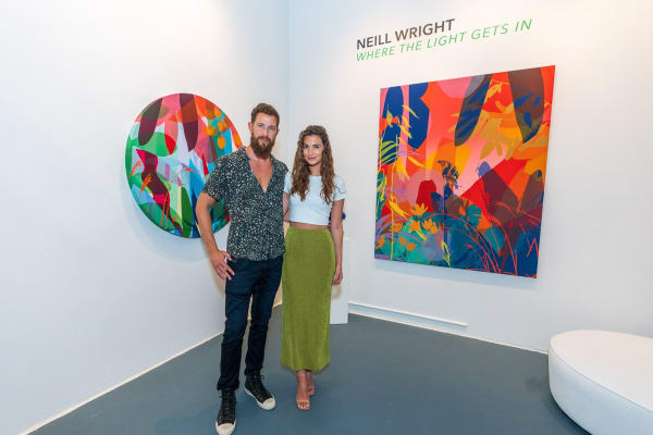 People inside Carousel Fine Art's Miami gallery space during Neill Wright's exhibition "Where the Light Gets In."