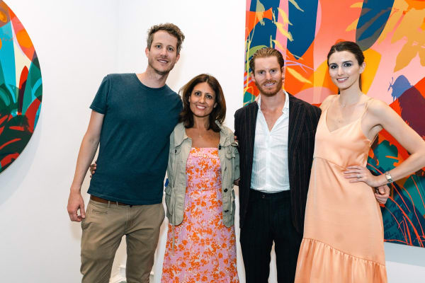 People inside Carousel Fine Art's Miami gallery space during Neill Wright's exhibition "Where the Light Gets In."