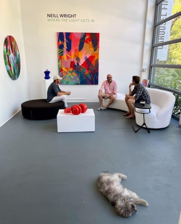 People inside Carousel Fine Art's Miami gallery space during Neill Wright's exhibition "Where the Light Gets In."