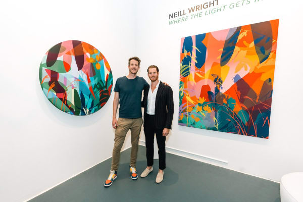 People inside Carousel Fine Art's Miami gallery space during Neill Wright's exhibition "Where the Light Gets In."