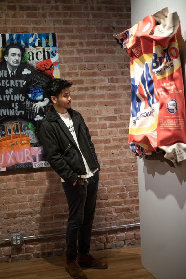 Man staring at painting displayed in Carousel Fine Art's Chicago gallery space during the Chicago Grand Opening.
