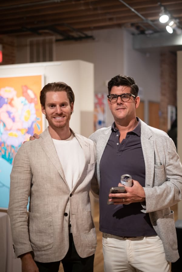 Men posing for photograph in Carousel Fine Art's Chicago location during the Chicago Grand Opening.
