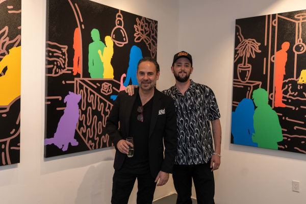 People posing at Carousel Fine Art's gallery space in Miami, FL during Chance Cooper's Spotlight Exhibition, "Between Me and You."