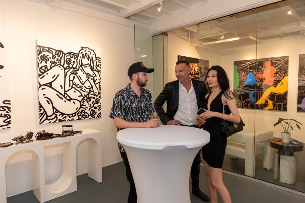 People at Carousel Fine Art's gallery space in Miami, FL during Chance Cooper's Spotlight Exhibition, "Between Me and You."