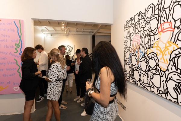 People at Carousel Fine Art's gallery space in Miami, FL during Chance Cooper's Spotlight Exhibition, "Between Me and You."