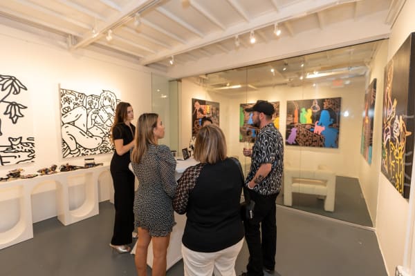 People at Carousel Fine Art's gallery space in Miami, FL during Chance Cooper's Spotlight Exhibition, "Between Me and You."
