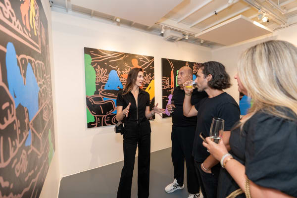 People at Carousel Fine Art's gallery space in Miami, FL during Chance Cooper's Spotlight Exhibition, "Between Me and You."