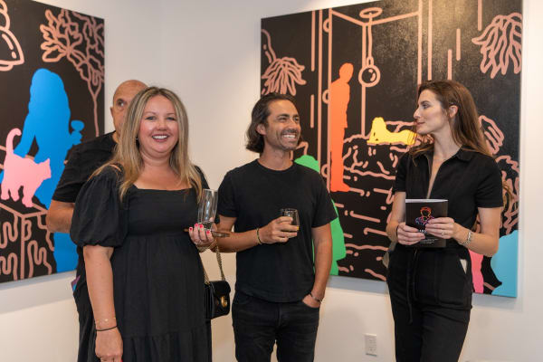 People at Carousel Fine Art's gallery space in Miami, FL during Chance Cooper's Spotlight Exhibition, "Between Me and You."