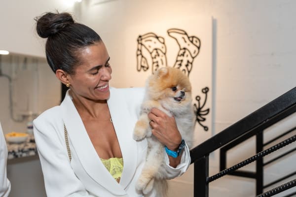 Woman with dog at Carousel Fine Art's gallery space in Miami, FL during Chance Cooper's Spotlight Exhibition, "Between Me and You."