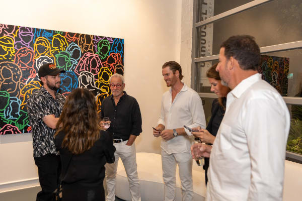 People at Carousel Fine Art's gallery space in Miami, FL during Chance Cooper's Spotlight Exhibition, "Between Me and You."