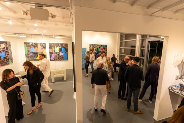 People at Carousel Fine Art's gallery space in Miami, FL during Chance Cooper's Spotlight Exhibition, "Between Me and You."