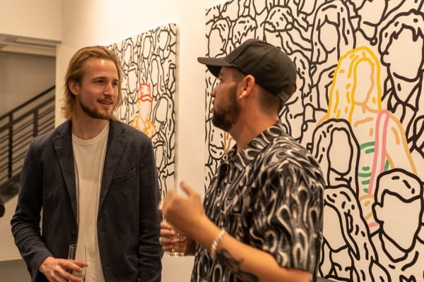 People at Carousel Fine Art's gallery space in Miami, FL during Chance Cooper's Spotlight Exhibition, "Between Me and You."
