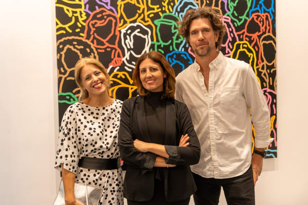 People posing at Carousel Fine Art's gallery space in Miami, FL during Chance Cooper's Spotlight Exhibition, "Between Me and You."