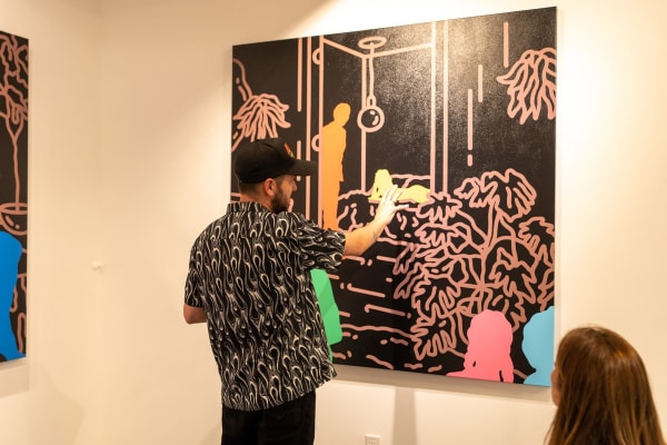 Artist Chance Cooper staring at Carousel Fine Art's gallery space in Miami, FL during Chance Cooper's Spotlight Exhibition, "Between Me and You."