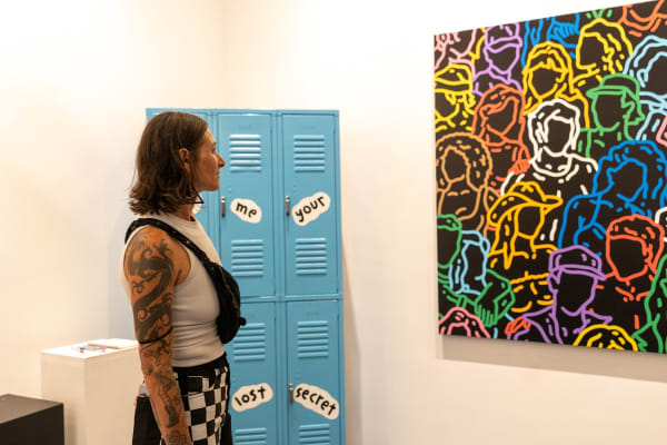 Person staring at Carousel Fine Art's gallery space in Miami, FL during Chance Cooper's Spotlight Exhibition, "Between Me and You."