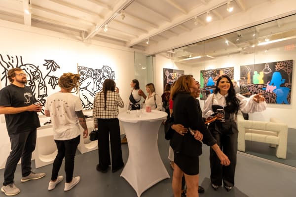 People at Carousel Fine Art's gallery space in Miami, FL during Chance Cooper's Spotlight Exhibition, "Between Me and You."