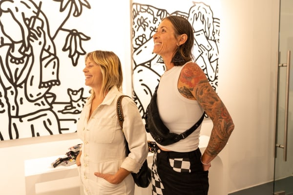 People staring at Carousel Fine Art's gallery space in Miami, FL during Chance Cooper's Spotlight Exhibition, "Between Me and You."