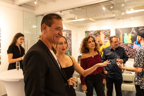 People at Carousel Fine Art's gallery space in Miami, FL during Chance Cooper's Spotlight Exhibition, "Between Me and You."