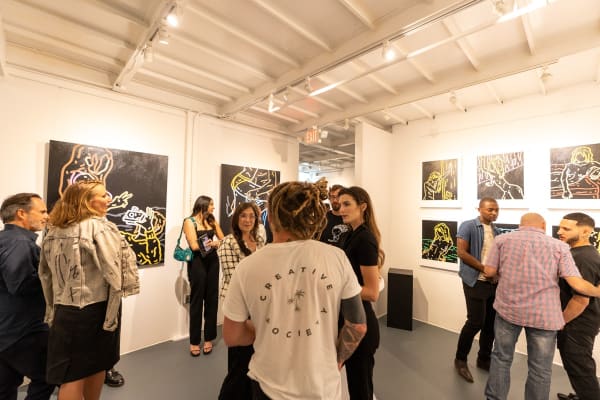 People at Carousel Fine Art's gallery space in Miami, FL during Chance Cooper's Spotlight Exhibition, "Between Me and You."