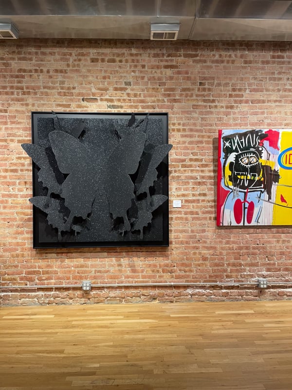 Paintings displayed on wall at Carousel Fine Art's gallery space in Chicago.