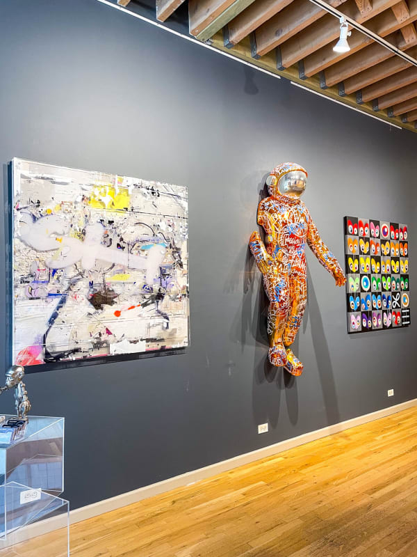 Wall with paintings and sculptures hung up in Carousel Fine Art's gallery space in Chicago.