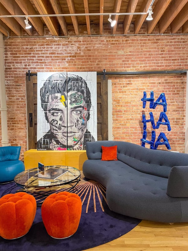 Paintings and sculpture displayed on wall at Carousel Fine Art's gallery space in Chicago.