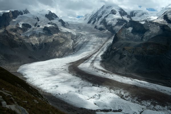 Digital photograph by Bernard Garo titled Ice Flow, 2023 — abstract depiction of a melting glacier with layered white, gray, and blue tones, printed on fine art etching paper and framed in black wood.