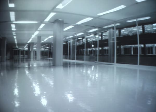 Building, 2006, A model of a Building made of wood and acryl, 4 video cameras, fluorescent lamp, video projector, motor, 300x600x190cm 빌딩, 2006, 나무, 아크릴, 형광등, 5대의 소형 비디오카메라, 4개의 모터, 비디오 프로젝터, 300x600x190cm