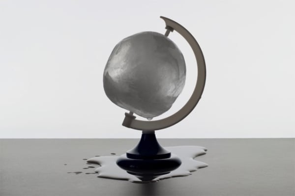 photograph of globe made of ice melting
