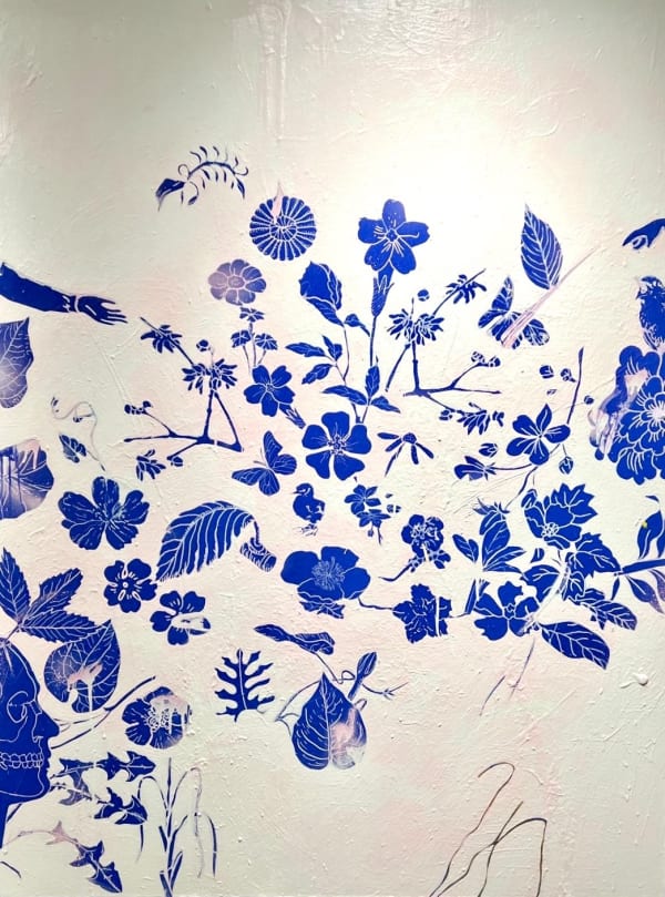 painting by Dan Baldwin of yves Klein blue symbols, skeleton head, bird and plants on white and pink background