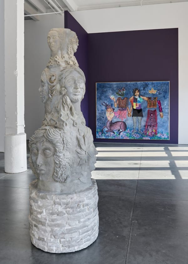 White sculpture by Chitra Ganesh in a gallery with a painting behind it