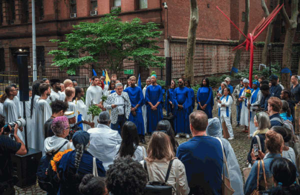 The poet Richard Blanco does a reading at Harlem Art Park on 120th Street before the start of the procession. Credit: Graham Dickie/The New York Times